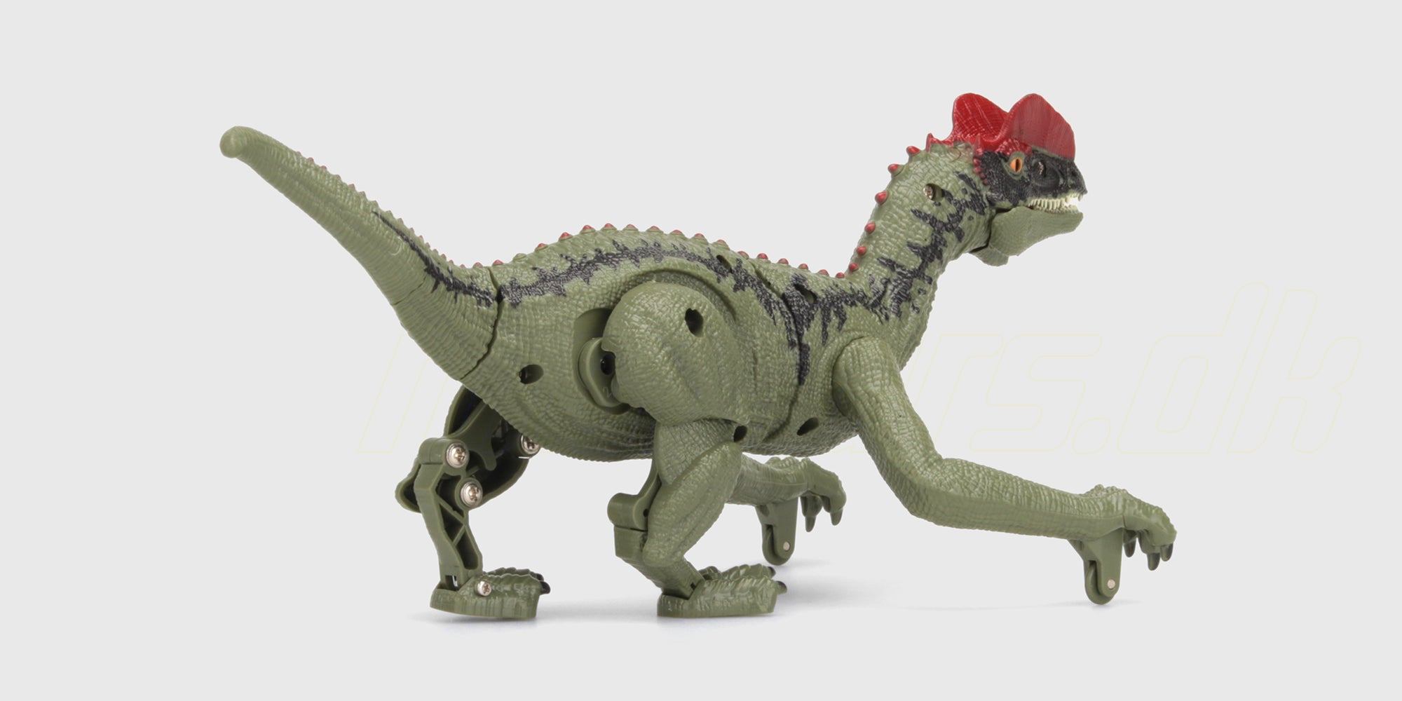 Grøn lille legetøjsdinosaurus med detaljerede skæl og pigge på ryggen set fra siden.