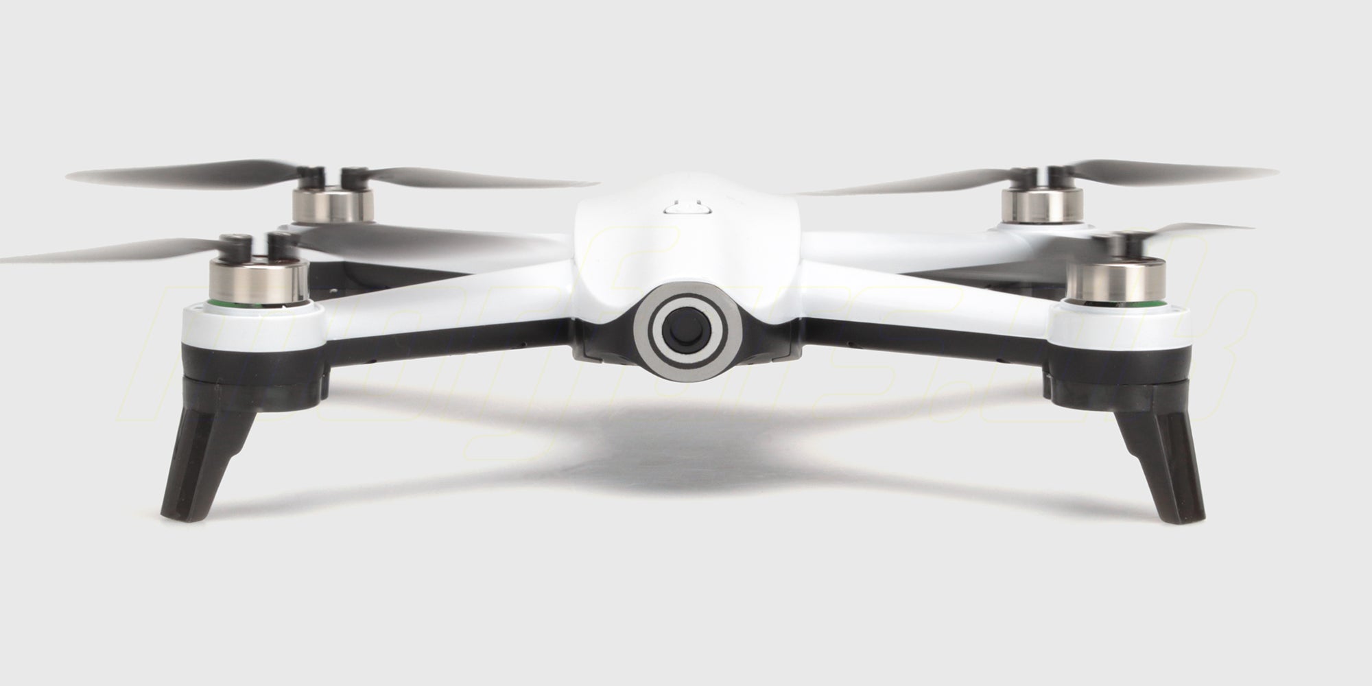 Sort Drone ST16B med foldbare arme og hvide propeller fotograferet fra siden på en hvid baggrund.